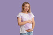 © Pixel-Shot - Happy pregnant woman on lilac background
