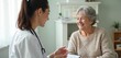 © Pete - Doctor, senior patient consult in clinic office during checkup appointment. Smiling elderly female receives support, care from medical pro, fostering trust, communication. Healthcare discussion.