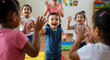 © NN AI - Happy diverse children clapping hands together in colorful classroom. Multicultural education and teamwork concept for preschool and elementary school programs