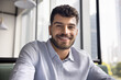 © fizkes - Screen webcam view headshot portrait smiling gen z male vlogger influencer looking at camera broadcast live stream from cafe. Happy young man expert freelancer join business video conference remotely