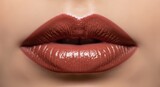 Close up view of woman’s glossy nude lips showing makeup with shine. Cosmetics advertisement and beauty industry concept for promotion.
