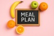 © TheWaterMeloonProjec - Pink background featuring a chalkboard with 'MEAL PLAN' and various fruits