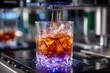© YouraPechkin - Crafting a refreshing drink with ice and vibrant lighting in a modern bar setting