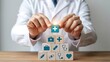 © REZAUL - Doctor stacking medical symbol blocks health care