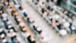 © Сергей Захаров - drone-view overhead of networking session at conference rows of white chairs and attendees holding notebooks focus