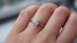 © HabibulAlamKhan - Close up of a woman s hand wearing a sparkling diamond engagement ring