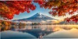 © MDSUMON - A stunning view of Mount Fuji during the colorful autumn season, surrounded by vibrant red and orange maple leaves at Lake Kawaguchiko.