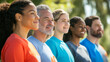 © Karina Korytchenko - Diverse group of people smiling and standing together outdoors in casual attire during a sunny day