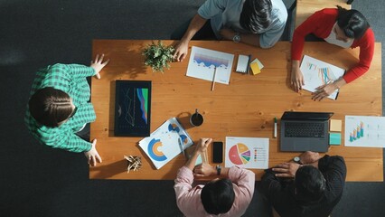 Wall Mural - top down view of manager holds tablet display increasing sales and placed on meeting table. group of