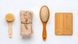 © Kunal - Flatlay of spa wellness beauty products including brush towel and wooden board on white background