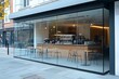 © Muhammad Saad - Contemporary coffee shop facade with large glass windows showcasing the cafe interior and seating area on the sidewalk.