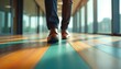 © Viktor - Man in formal suit, brown shoes walks on colorful striped wooden floor. Bright light from windows creates shadows. Represents business progress, career advancement, pro success in modern workplace.