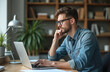 © Viktor - Pensive millennial man works on laptop in home office. Thoughtful young male employee analyzes project documents online using computer. Focused man ponders ideas, plans solution for business task.