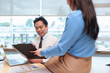 © Pichsakul - Asian business people discuss data charts collaborate review reports office workspace