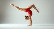 © salahudin - A female gymnast in a handstand, legs extended