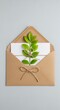 © Manji - Botanical Letter Fresh Green Leaves in Brown Envelope with White Card on Gray Background