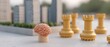 © Narongsag - A brain on a pedestal with chess rooks and city skyline in background Strategy