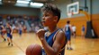 © BlackCat - A perspiring young basketball player, likely between 15 to 18 years old, with a determined expression, sweat-drenched jersey, and flushed cheeks, catches their breath during a intense game in a well-l