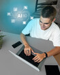 © fotofabrika - Young man engaged in creative work using a laptop and exploring artificial intelligence concepts at home