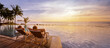 © Song_about_summer - beach vacations, young couple in luxury hotel resort, man and woman relaxing near swimming pool at sunset