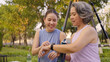 © ChayTee - Young adult child middle age old mum look at AI smart watch IOT workout app ECG rate data result. Love health care older aged mom asia elder people happy sport wear wrist trace help protect aging life