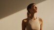 © Dmitrii - Young woman practicing mindfulness while standing in soft light