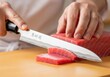 © Aurora Aesthetics - Sushi Chef Slicing Fresh Tuna, a professional cook uses a sharp knife to prepare fish for Japanese cuisine