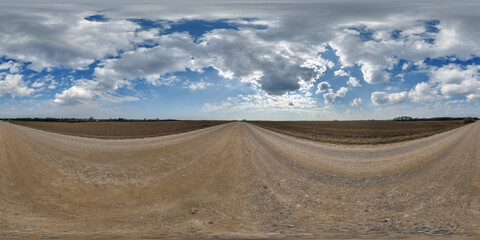 Wall Mural - hdri 360 panorama view on gravel road among fields with clouds in sky in equirectangular full seamle
