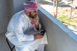 © Jack Tamrong - Arabic architect man in traditional Arab cloth and headscarf sitting and relax during break time in construction site