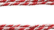 © Mona - Red and white twisted candy canes border on a white background top and bottom