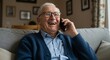 © Arif - Joyful senior man with glasses laughing during a phone conversation at home