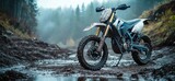 Dirt bike in a muddy forest path