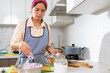 © Guillermo Spelucin - Young latin american chef preparing ceviche with red onions in a modern kitchen