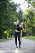 © thatinchan - Portrait of beautiful female runner wearing workout clothes and warm up her body get ready for jogging in morning get good health. female runner warm up her body alone get ready for jogging in park.