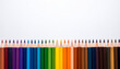 © DenisART - Perfectly aligned colored pencils forming a colorful bottom border on white background