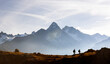 © Ivan Kmit - Two hikers walking above Lac de Cheserys in the French Alps near Chamonix. Scenic Monte Bianco range mountain view with Mont Blanc peaks and alpine adventure vibe