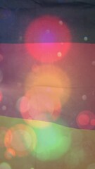 Wall Mural - colorful light bokeh animation overlaying german flag