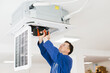 © dsheremeta - Hvac technician installing air conditioner unit using cordless drill