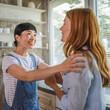 © Miljan Živković - Excited japanese woman share good news with her friend at home