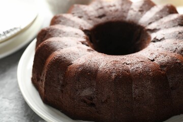 Wall Mural - tasty chocolate bundt cake on grey table, closeup