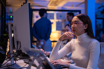 asian software engineer or programmer team working late in development office,problem solving or alg