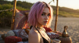 Woman with short pink wavy hair in a black bikini top at a boho beach setup at sunset. Edgy summer style and festival vibes. For alternative fashion, hair color trends, or music event promotions