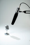 Studio microphone for podcasting or streaming on a boom arm with a vintage classic mic on a white background