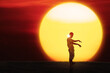 © Creativa Images - Zombie Silhouette at Sunset with Dramatic Sun Background