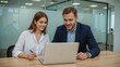 © Muhammad - Business Team Working Together on Laptop in Modern Office