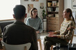 © Mediaphotos - Group of women and men sitting in therapy session, engaging in conversation, sharing experiences, participating in mental health support