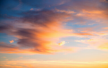 Wall Mural - Gorgeous sunset fills the sky with hues of orange and purple, casting a warm glow over the peaceful horizon.