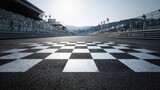 The checkered finish line at a motorsport race track under clear skies.