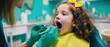© Ruslana - The young girl enjoying her dental check-up at the clinic.