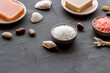 © 9dreamstudio - Spa treatment body care cosmetics close up. Sea salt in bowls and soap with sea shells
